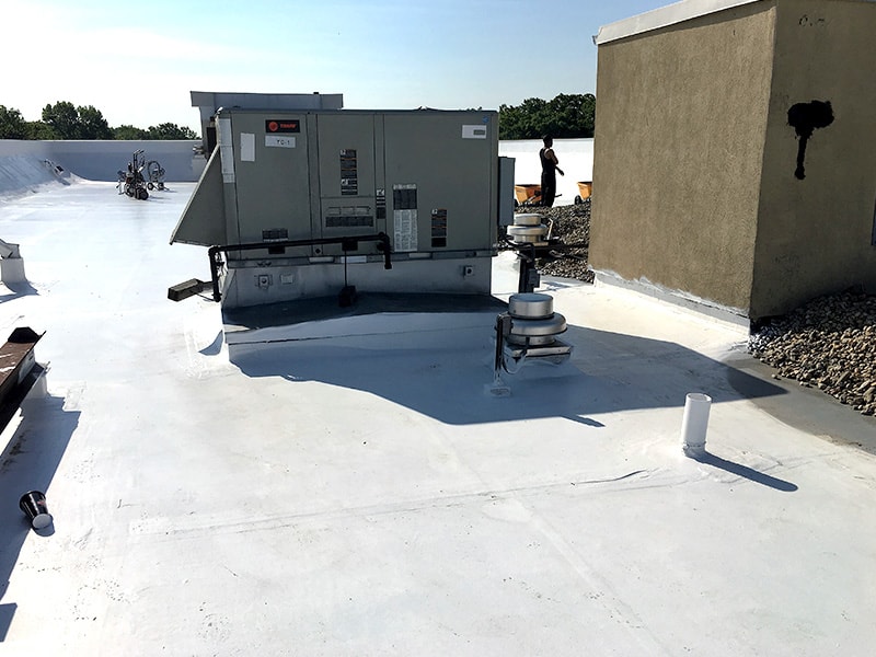 Ballasted Roof Silicone Roof Coating Progress Shot Before Replacement of Stone