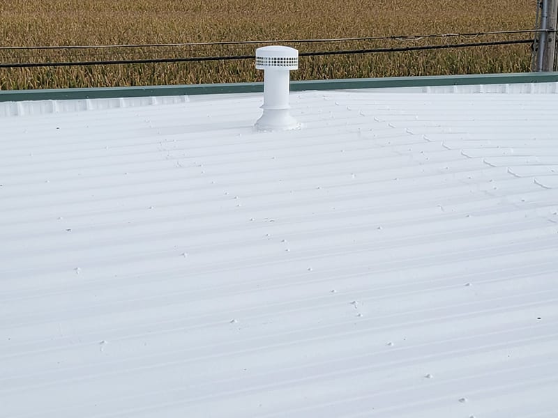 Image of a wide view of a metal roof restored with 2 coats of an AP-6100 Modified Liquid Rubber Roof Coating system.