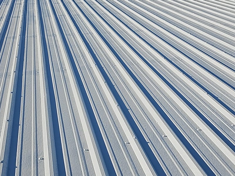 Image of a metal roof restored with 2 coats of AP-6100 Modified Liquid Rubber Roof Coating system.