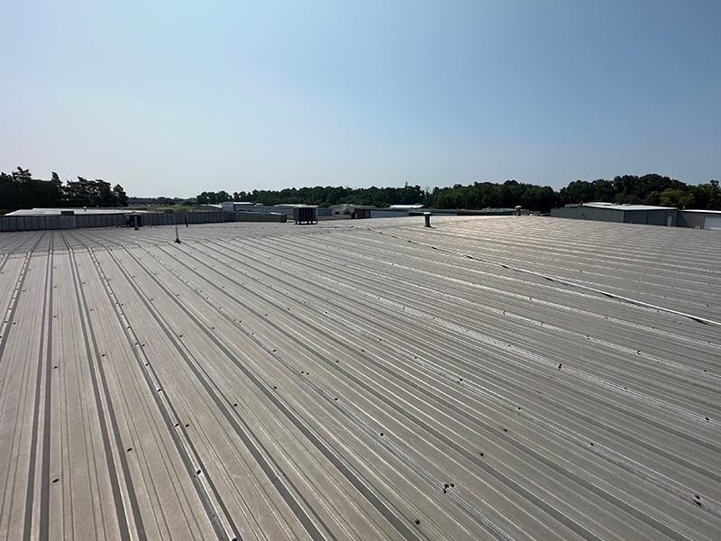Image of a wide view of large metal roof prior to restoration.
