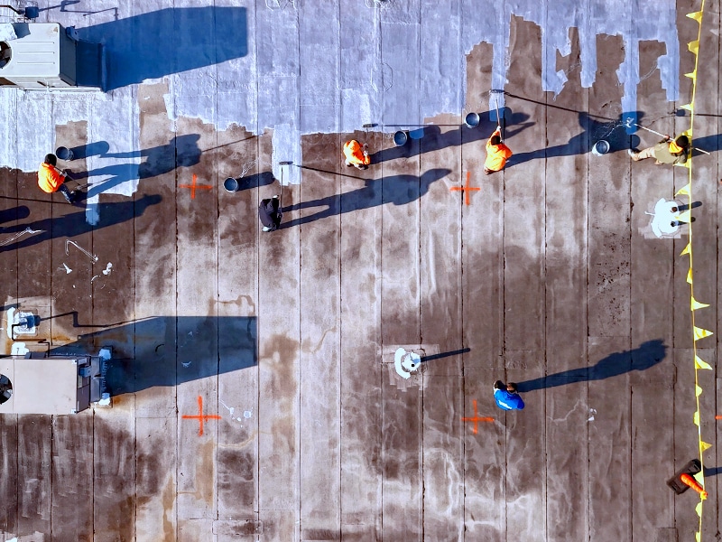 Image of Deptford Shopping Center Deptford, NJ - AP-5100 Moisture Cure Polyurethane Base Coat Roll Application in Progress from Drone View Above