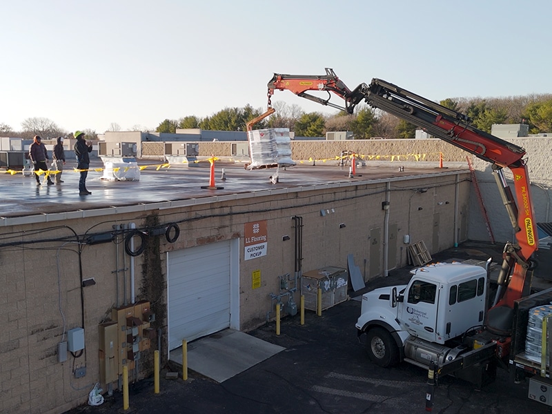 Image of Deptford Shopping Center Deptford, NJ - Pallet of AP-5100 Moisture Cure Polyurethane Pails Boom Lifted onto Roof By Distributor