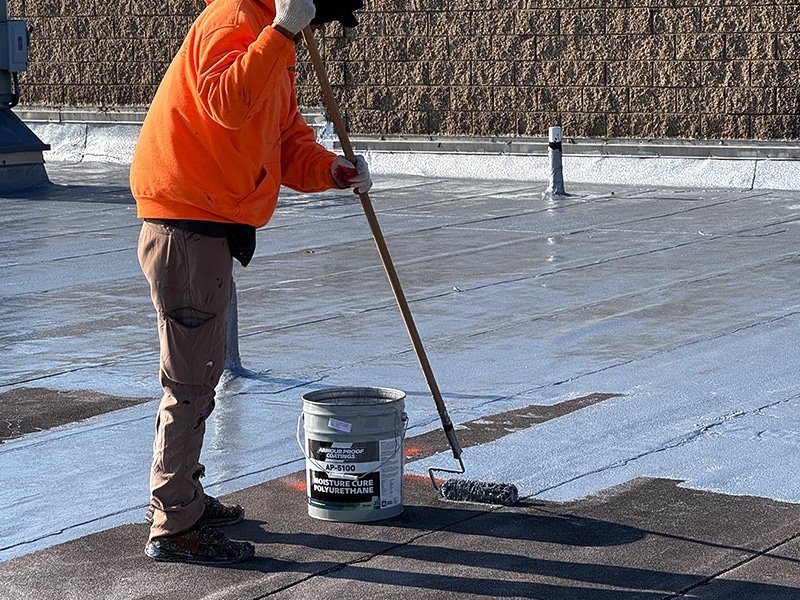 Image of Deptford Shopping Center Deptford, NJ - AP-5100 Moisture Cure Polyurethane Roof Restoration Coating System Roller Application Up Close Roof Level